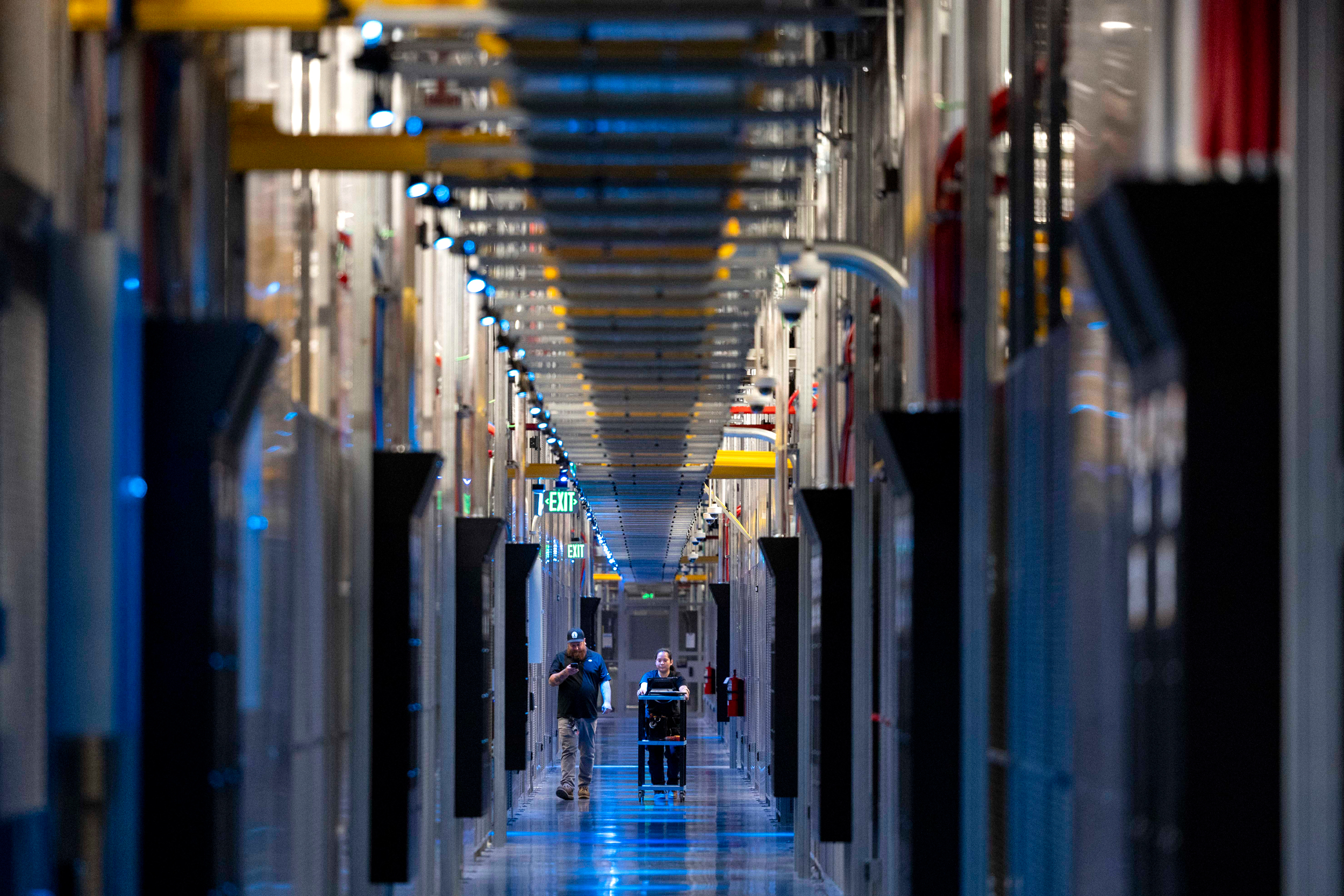 People walk through the hallways at Equinix Data Center in Ashburn, Va., on May 9. Credit: Amanda Andrade-Rhoades/The Washington Post via Getty Images