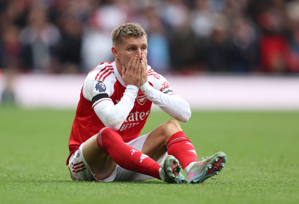 Martin Odegaard looks upset after suffering an injury during an Arsenal game