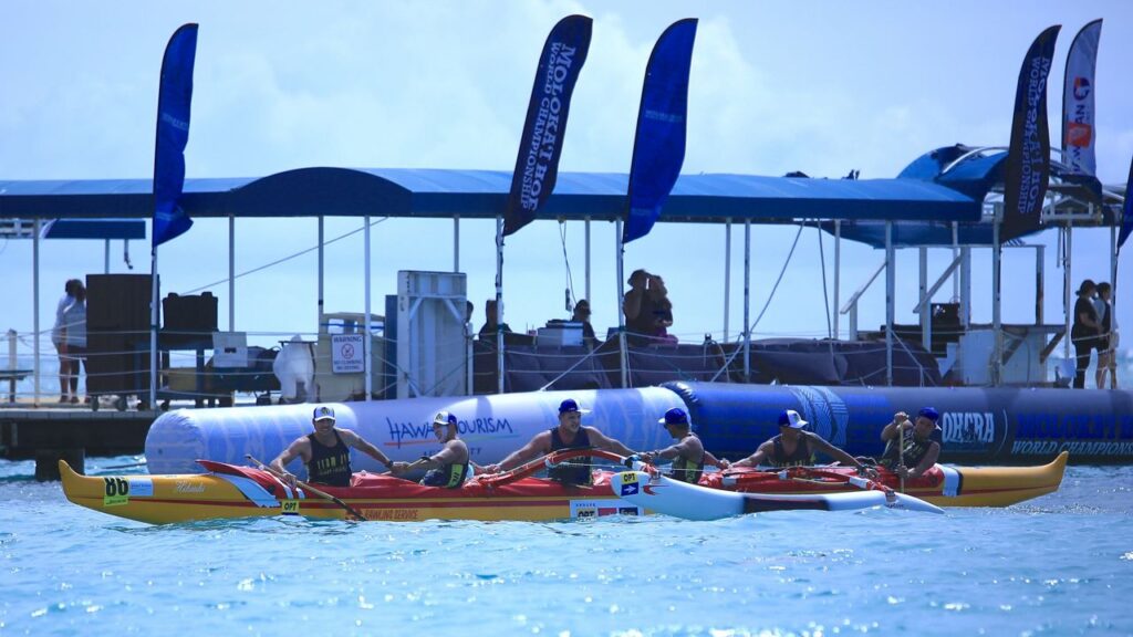 Members of Tahitian crew Team OPT joined hands as they passed the finish buoy at Kahanamoku Beach to win the Molokai Hoe men's distance paddling world championship on Sunday.