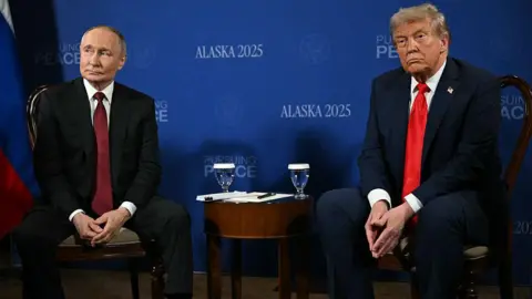 Getty Images Trump and Putin sitting next to each other during a summit on Ukraine in August.