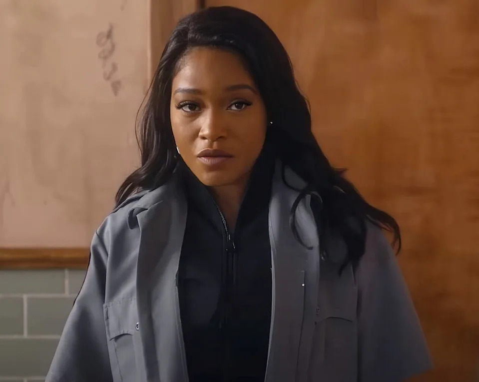 Keke Palmer is wearing a gray jacket and black top