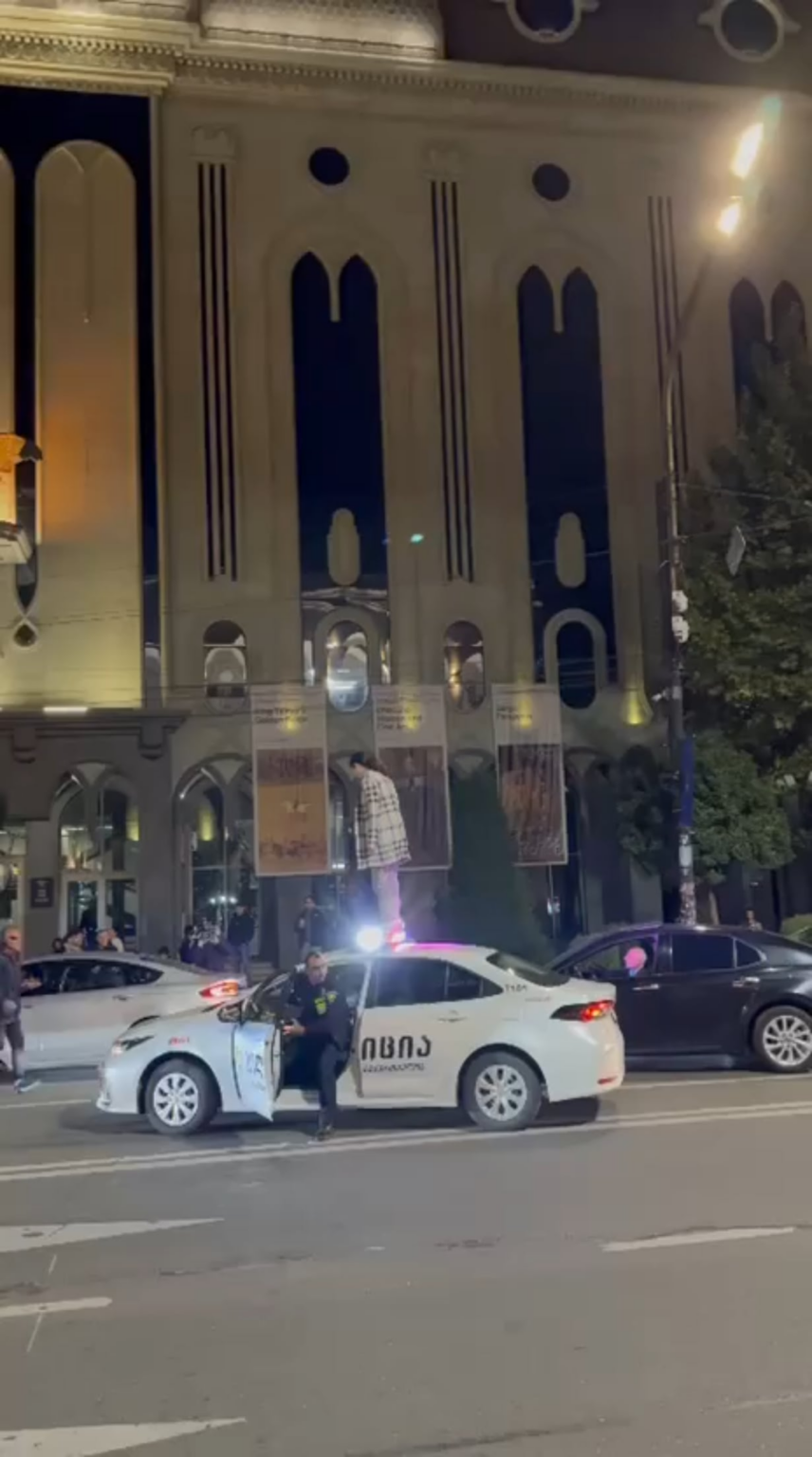 Georgian protester Tamar Lortkipanidze arrested under “hooliganism” charges after climbing a police car in support of jailed journalist Mzia Amagloberi