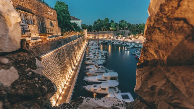 Rocks and harbor at sunset