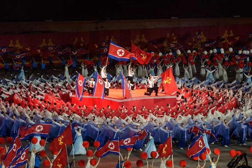 Participants take part in the ‘Long Live the Workers’ Party of Korea’ performance to celebrate the 80th founding anniversary of the Workers’ Party of Korea at the May Day Stadium in Pyongyang on 9 October 2025 (AFP via Getty Images)
