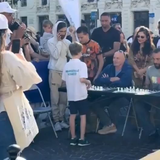 Luca Protopopescu, 9 years old, played a simultaneous chess match with 12 opponents at a Marseille festival