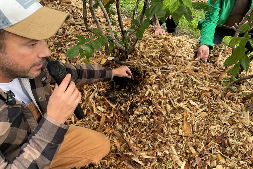 Man with microphone holding soil
