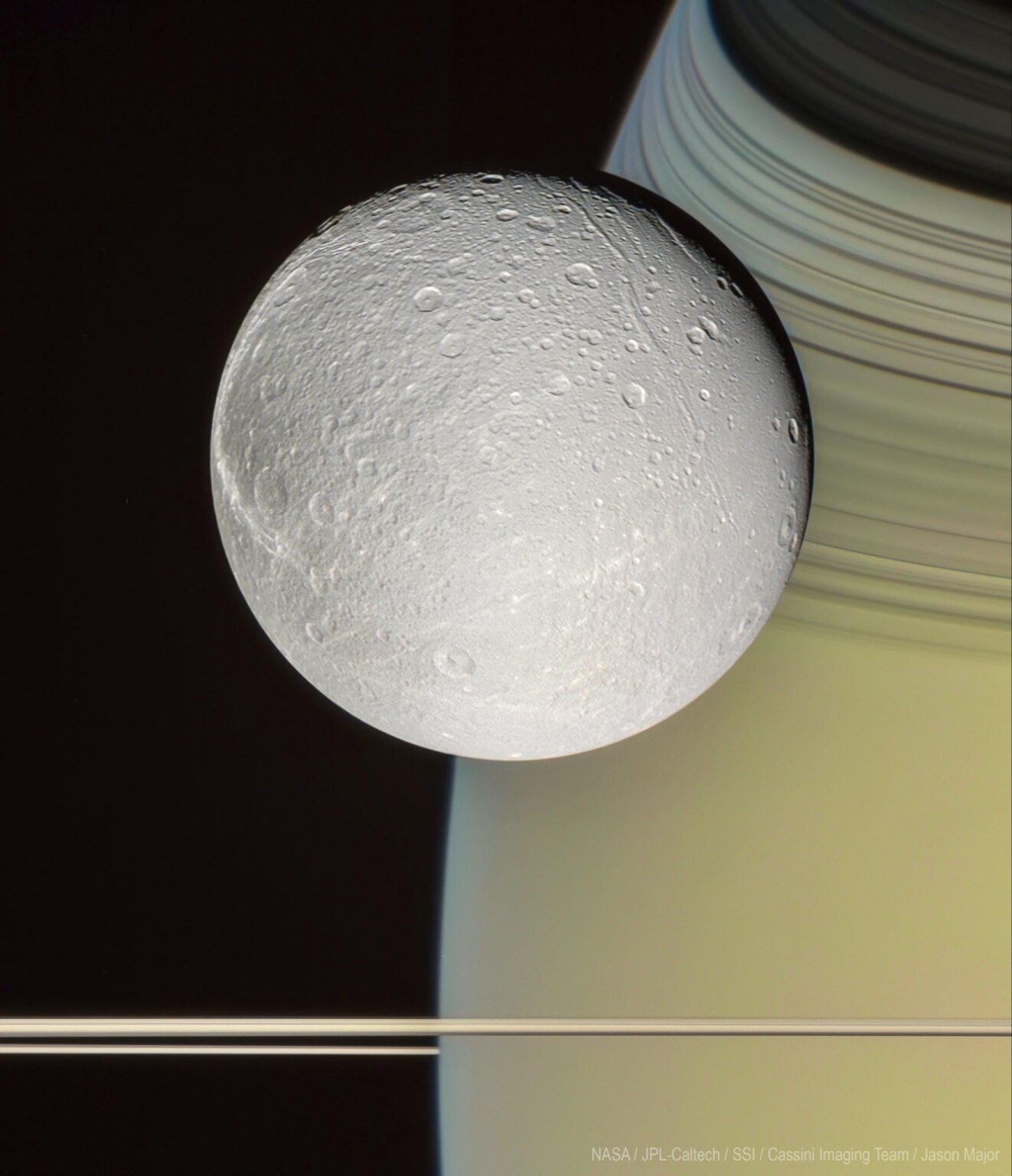 Cassini captured this breathtaking shot of Dione in front of Saturn 20 years ago today
