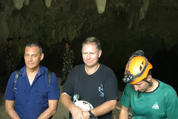 Triumphant return: Craig Challen (left), Harris and American Joshua David Morris at the entrance to Tham Luang Cave in Thailand in 2019.