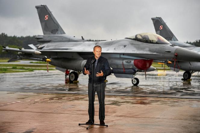 Polish Prime Minister Donald Tusk stands in front of Polish F-16 fighter jets during a press conference addressing the threat posed by Russian drones in the country's airspace, in Lask, Poland, on September 11, 2025.