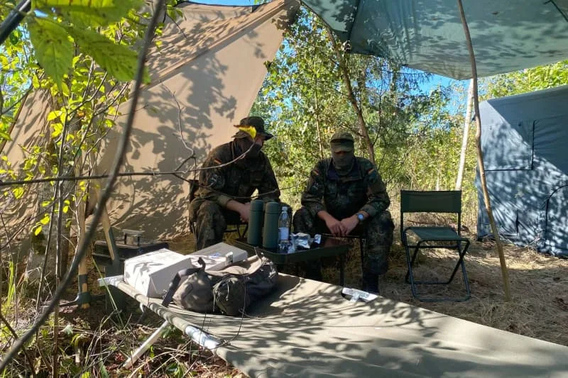 Two Bundeswehr soldiers sit in their field camp in a position near the Lithuanian border to the Russian Baltic Sea exclave of Kaliningrad. Alexander Welscher/dpa