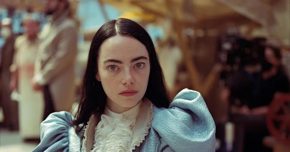 Emma Stone in a puffy dress on a the set of Poor Things