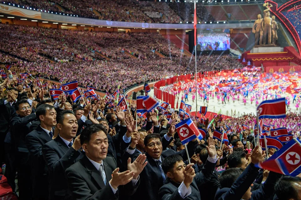 Spectators react during the ‘Long Live the Workers’ Party of Korea’ performance to celebrate the 80th founding anniversary of the Workers’ Party of Korea at the May Day Stadium in Pyongyang on 9 October 2025 (AFP via Getty Images)