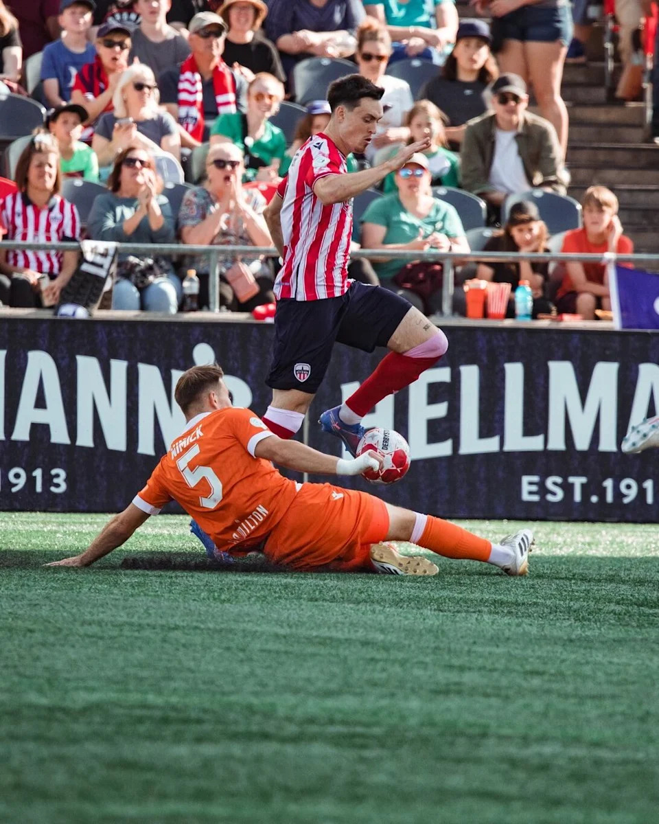 Atlético Ottawa's Sam Salter works around a Forge FC tackle on Sept. 21, 2025.