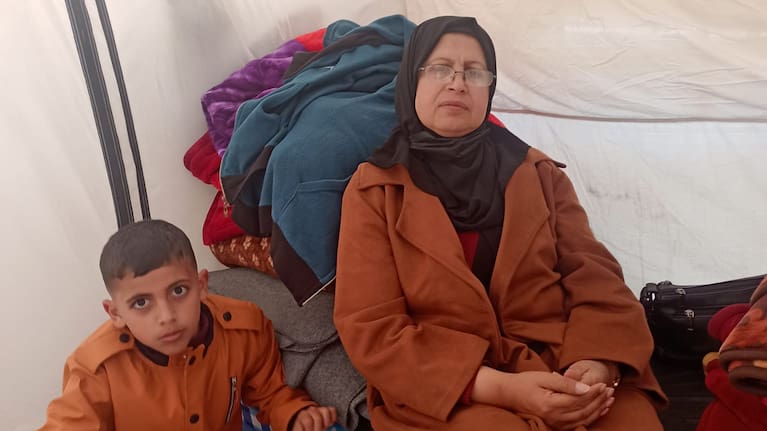 Musa Abusaileek and his aunt Nima Alhaj inside a tent in Khan Younis where they sought temporary shelter. 
