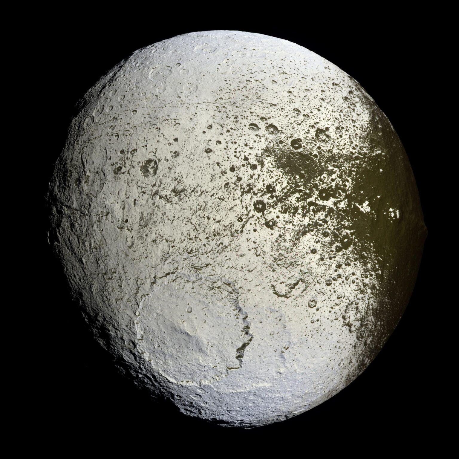 Cassini captures the first high-resolution glimpse of the bright trailing hemisphere of Saturn's moon Iapetus in 2007.