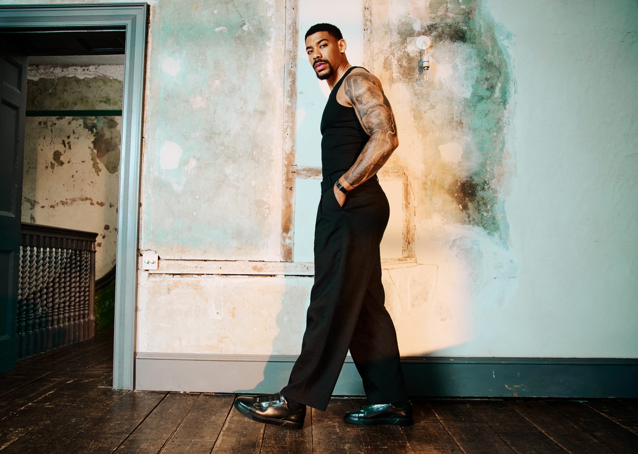 aaron pierre. uniqlo tank\, cos trousers\, boss shoes\, cartier watch.