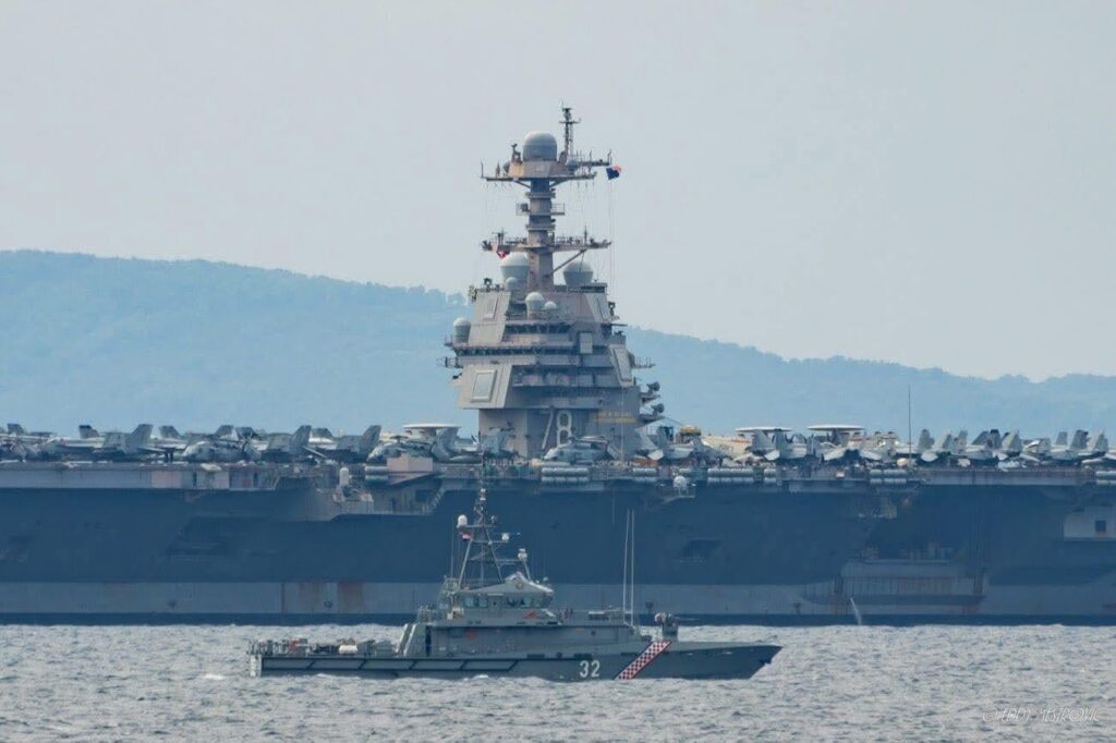 Croatian coast guard ship (43m long) next to USS Gerald R Ford