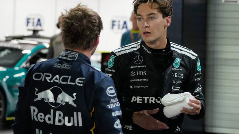 Mercedes driver George Russell of Britain, right, talks to Red Bull driver Max Verstappen of the Netherlands after the qualifying for the Singapore Formula One Grand Prix 