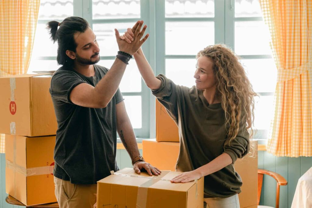 A man and a woman giving each other a high-five 
