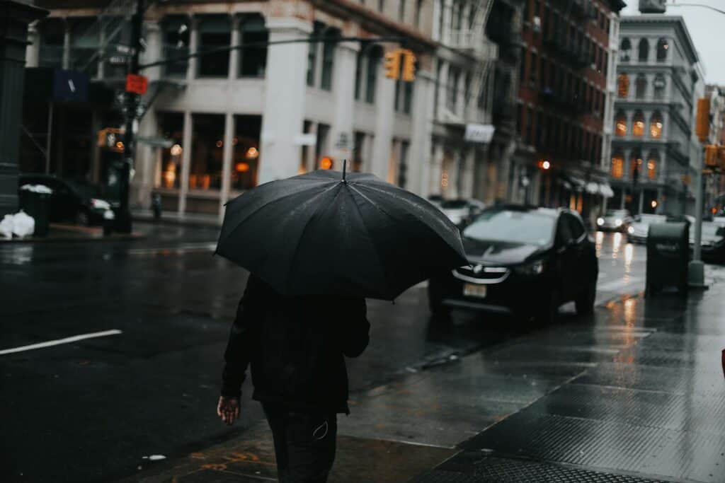A man walking down the street with an umbrella
