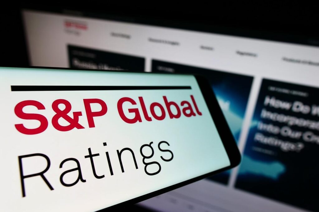 Photo illustration depicts S&P Global Ratings logo displayed on a smartphone, with the agency’s official website in the background, accessed on Mar. 24, 2025. (Adobe Stock Photo)