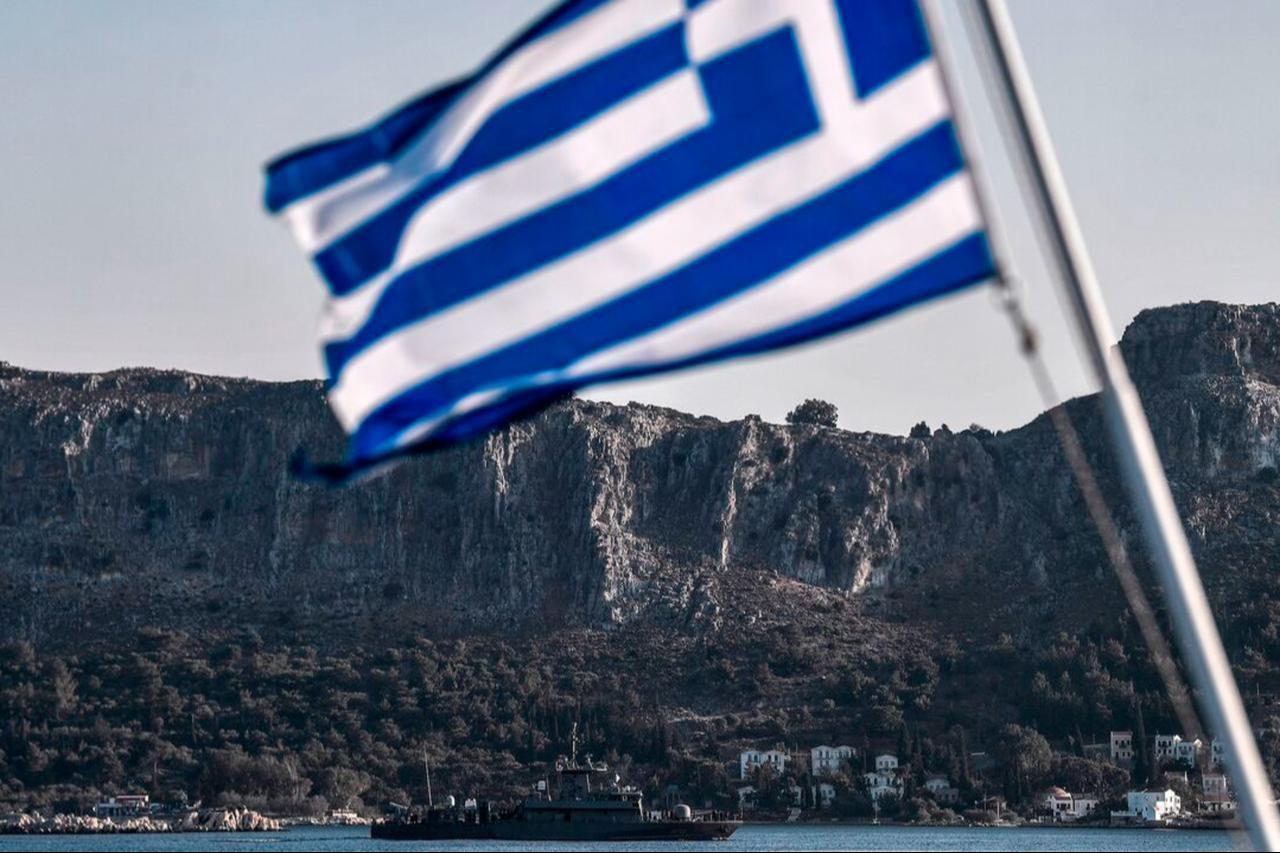 The Greek Navy Roussen or Super Vita class Fast Missile Patrol Boat P 71 HS Ritsos patrols off the tiny island of Kastellorizo (Megisti) in front of a Greek flag, August 28, 2020. (AFP Photo)