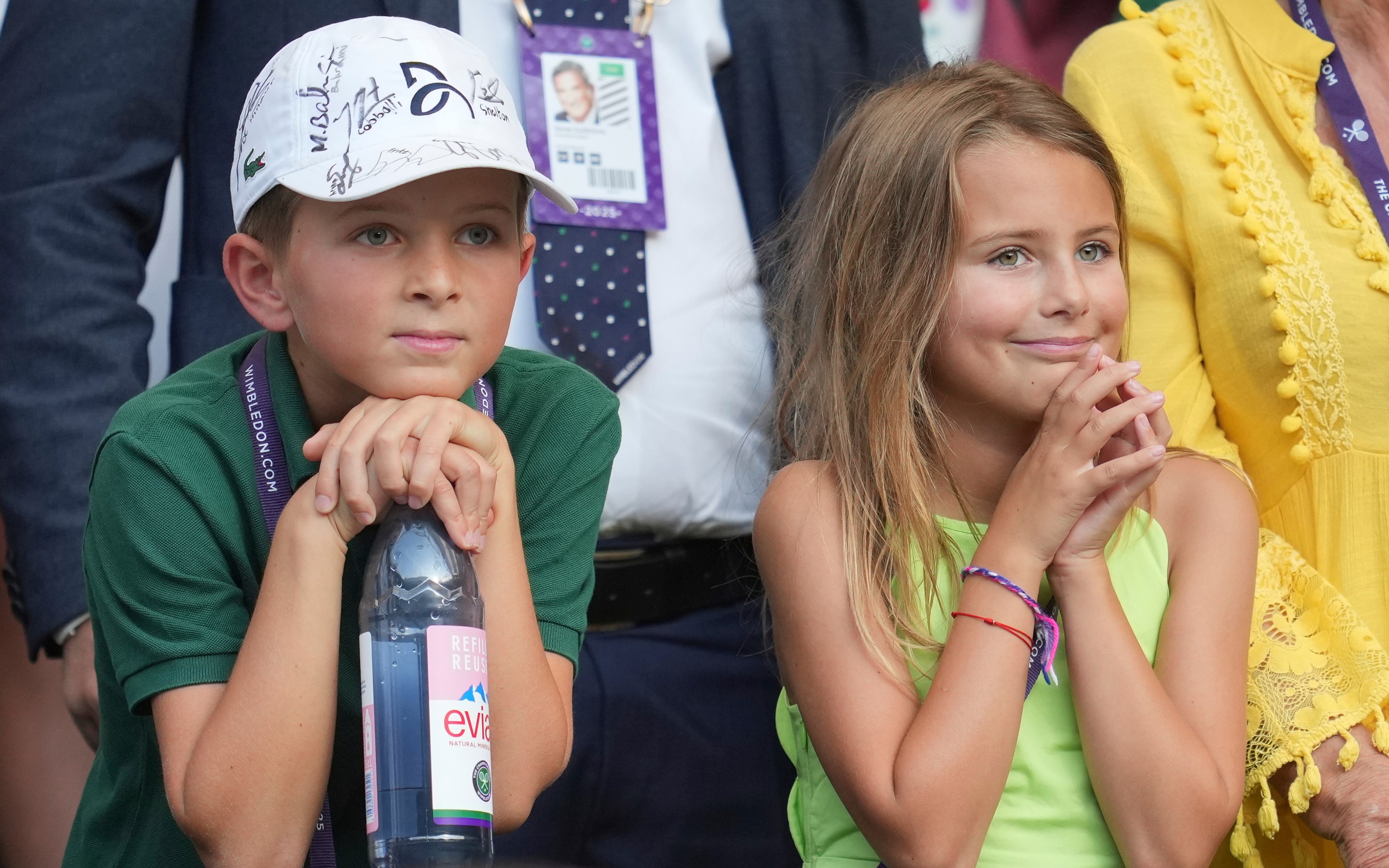 Novak Djokovic's children, Stefan and Tara, smile watching their father play at Wimbledon.