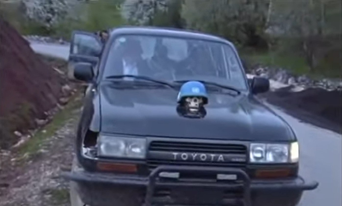 A black Toyota SUV with a skull wearing a UN helmet mounted on its hood, with "212 B.B.R. Srebrenik" text overlay.