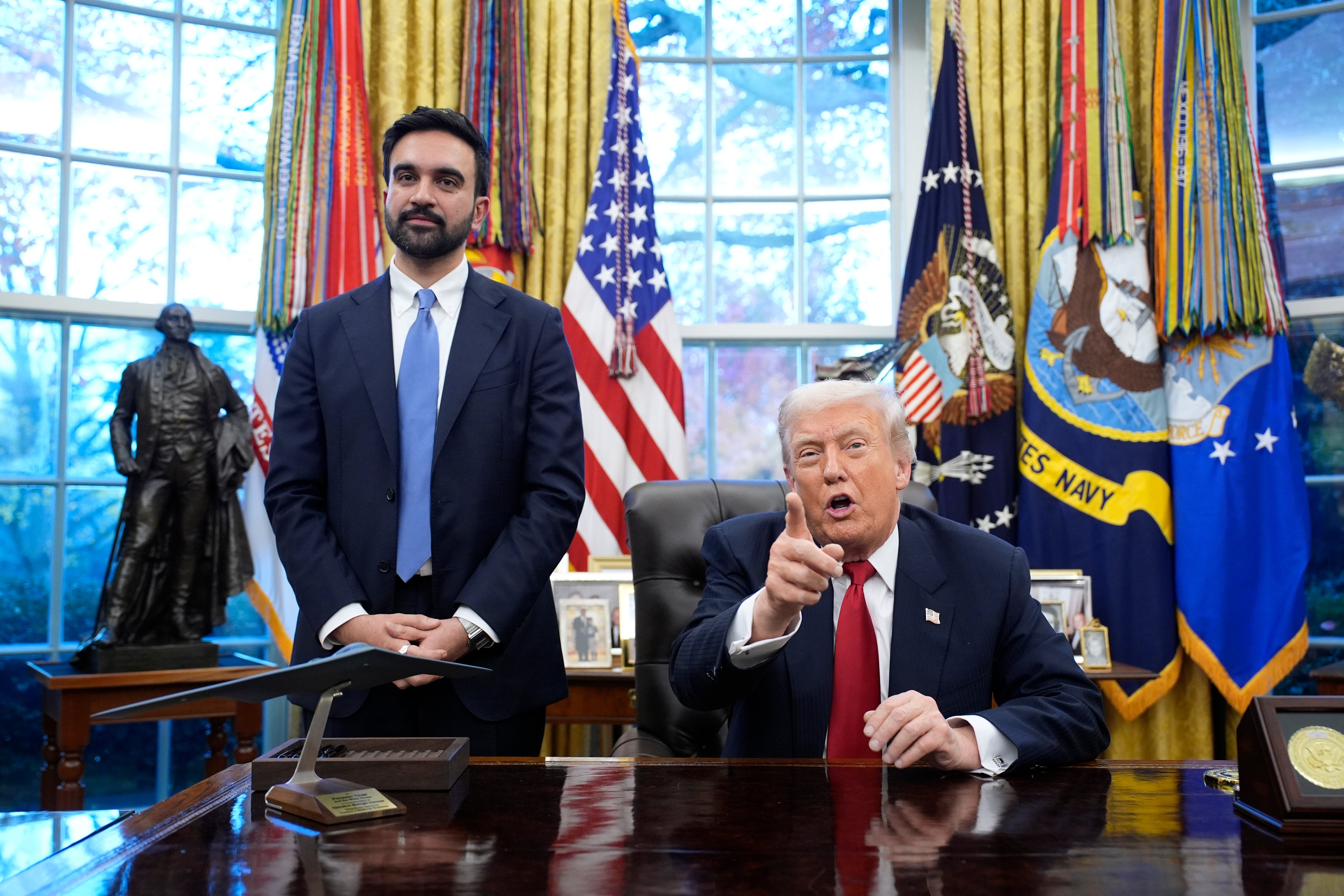 Donald Trump pointing at the viewer while Zohran Mamdani stands to his left in the Oval Office.