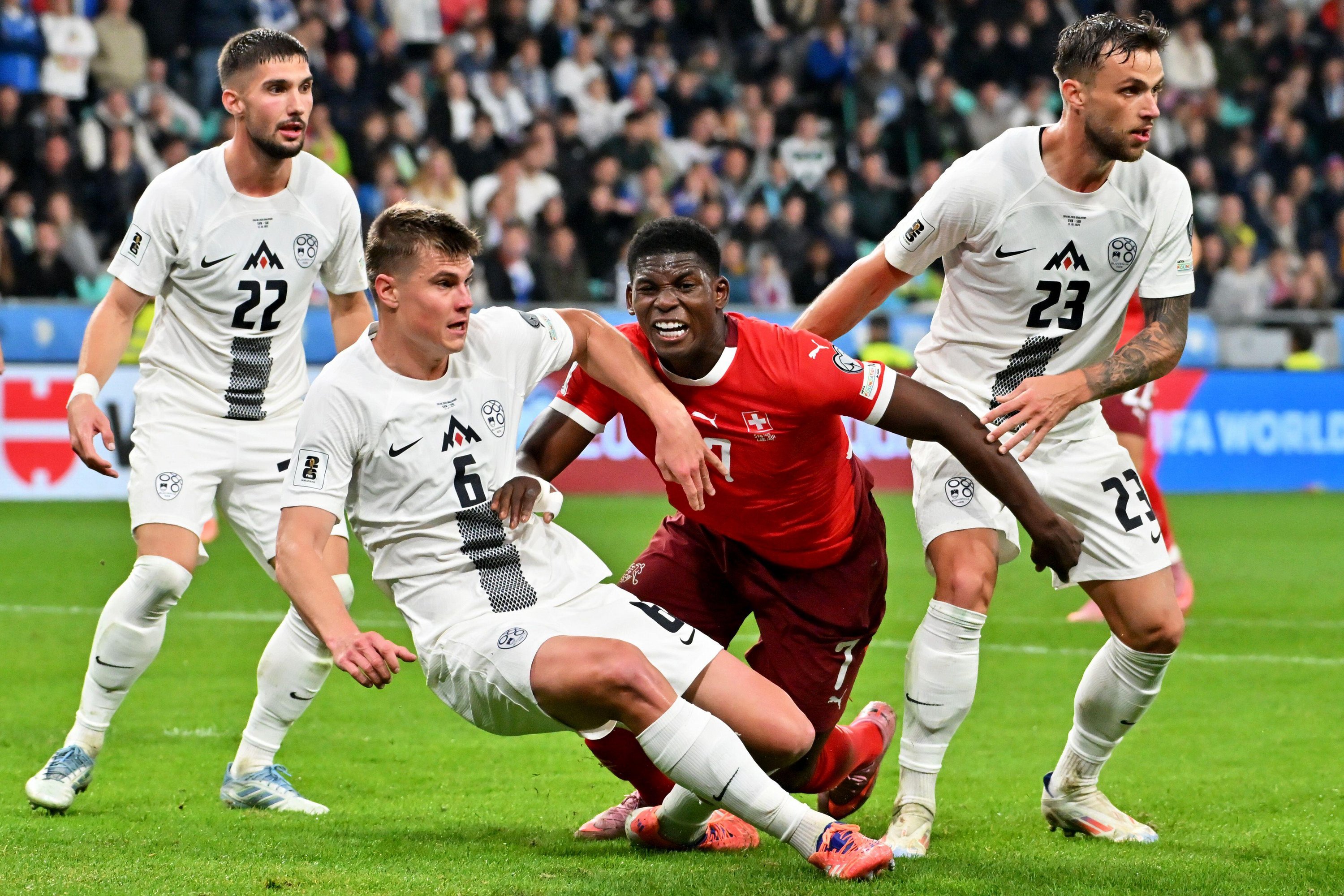 Ljubljana, Slovenia. 13th Oct, 2025. Ljubljana, Slovenia, October 13th 2025, Breel Embolo of Switzerland (2R) in action against David Brekalo of Slovenia (R) during the UEFA European Qualifiers for 2026 World Cup, Group B match between Slovenia and S