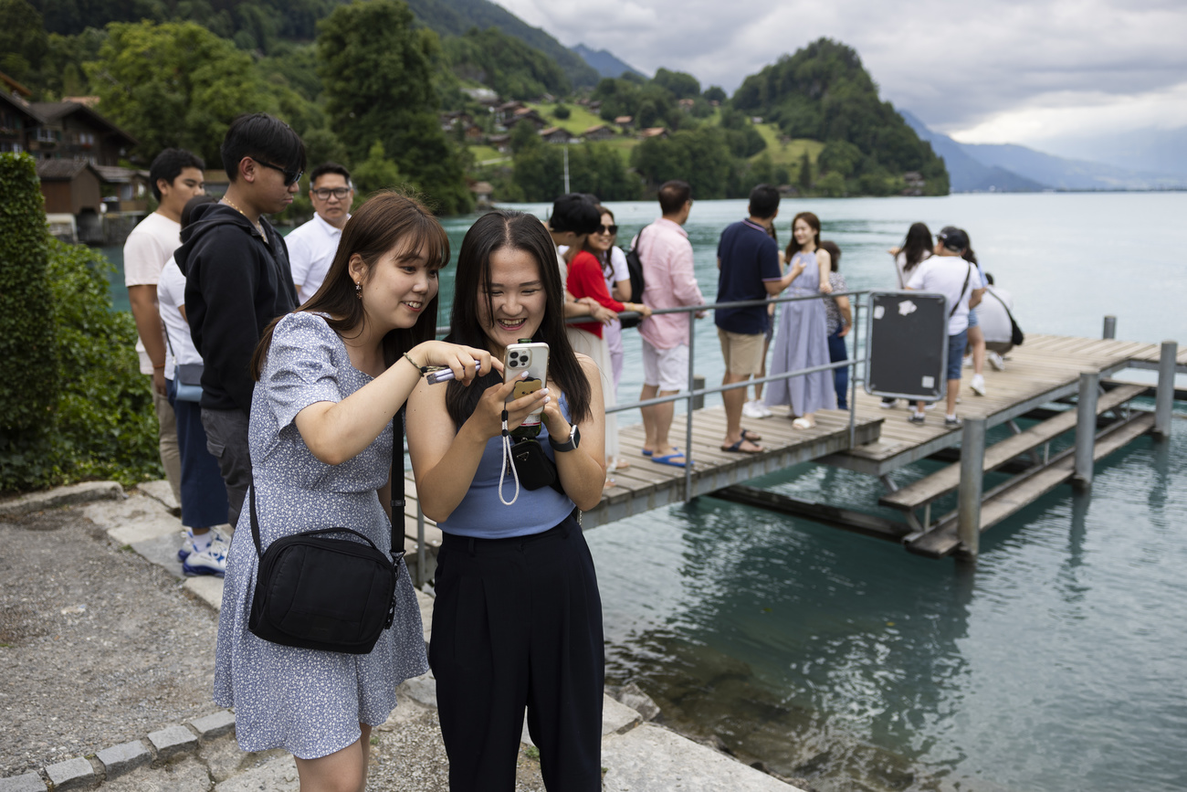 Asian tourists taking photos at the pier in Iseltwald, where Crash Landing on You was filmed.