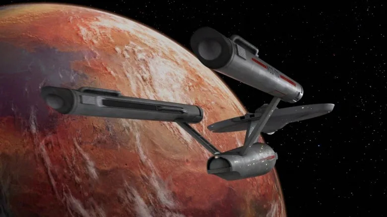 The Enterprise entering orbit of a distant planet on Star Trek