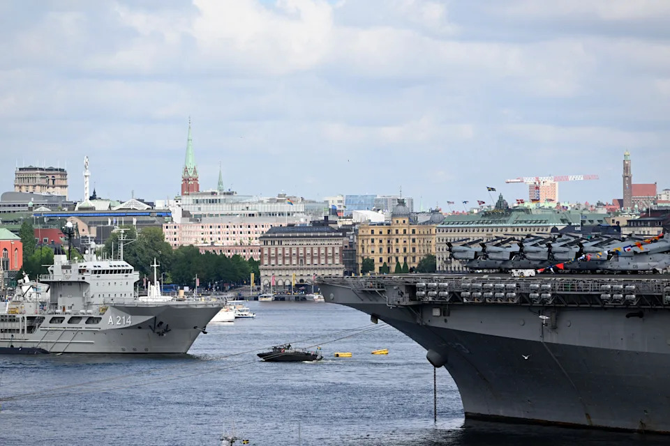 Wasp-class amphibious assault ship USS Kearsarge of the U.S. Navy is seen at right, next to the HSwMS Belos submarine rescue ship of the Swedish Navy (left) in the harbor in Stockholm, Sweden, in a June 3, 2022, file photo taken ahead of a NATO exercise in the southern Baltic Sea. / Credit: HENRIK MONTGOMERY/TT News Agency/AFP/Getty
