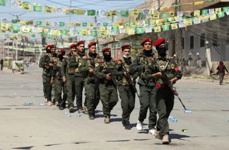 Armed members of the Syrian Democratic Forces' (SDF) military police take part in a demonstration under the banner “With our will, we will protect our revolution.” in Qamishli, Syria, September 17, 2025. (credit: REUTERS/Orhan Qereman)
