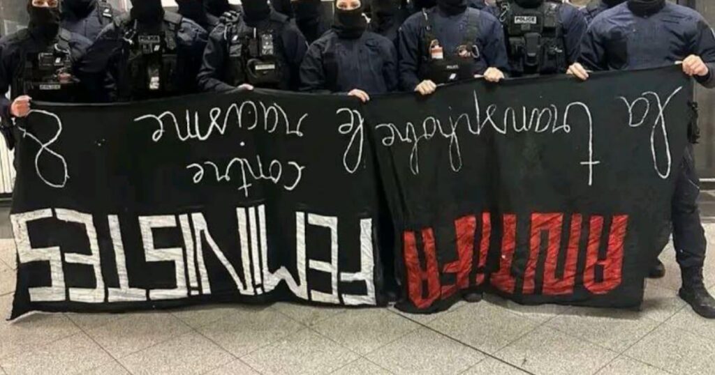 An administrative investigation opened into a photo of police officers posing behind an upside-down feminist banner