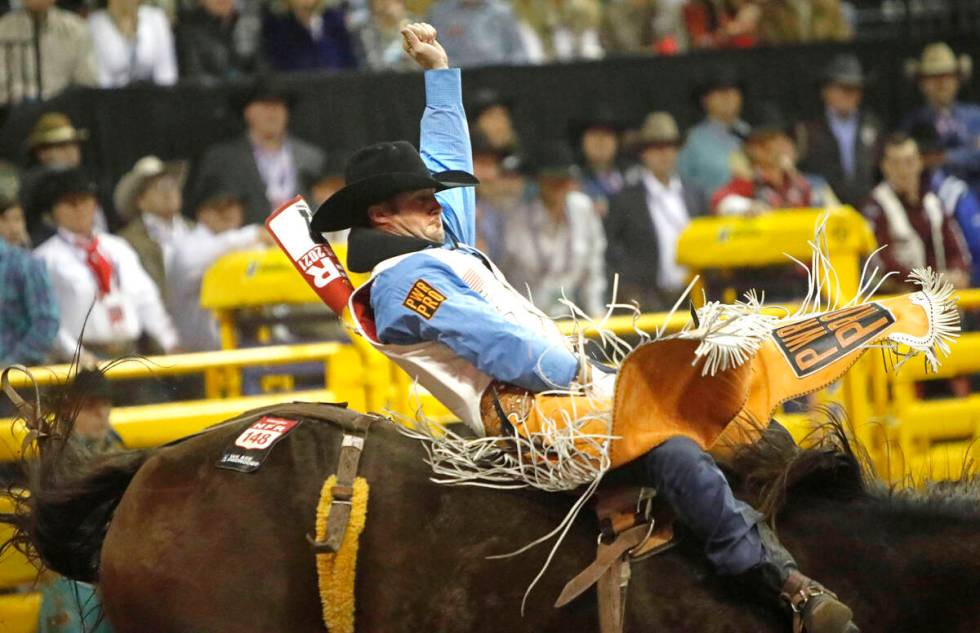 Kaycee Feild of Genola, Utah competes in the bareback riding event during the eighth go-round o ...