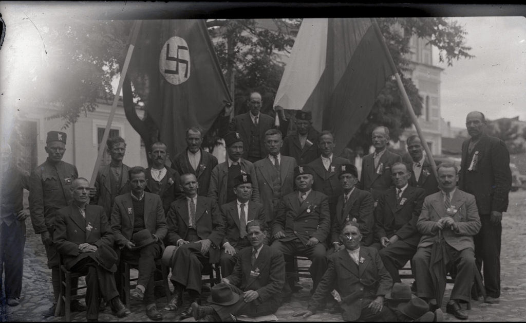 A group of supporters of Nazi Germany during WW2 together with officers of the Bulgarian occupation. Photo taken in the courtyard of the "Macedonia" cinema, Bitola (circa 1941)