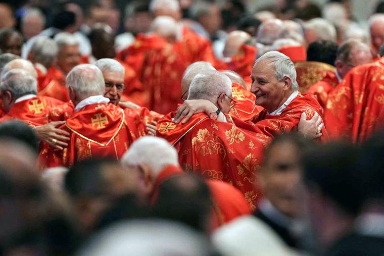 Cardinal Matteo Maria Zuppi (r), president of the Italian Episcopal Conference, attends Mass in St Peter's Basilica on May 7, 2025.