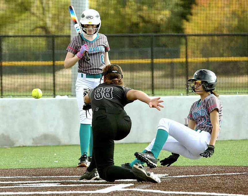 Lamar County Leopards' Katelyn Smith slides toward home plate as TK Smoke pitcher Sarah Turner-Stepp reaches for the ball on Mickey Moore Field in a 14U game of the Turkey Trot on Turf tournament Sunday, Nov. 16, 2025, at the Swanger Complex in Texarkana, Texas. Smith was safe. The tournament is hosted by RKS Tournaments and raises money for Randy Sams' Outreach Shelter. (Staff photo by Stevon Gamble)
