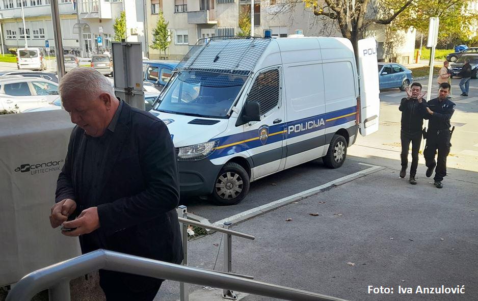 Josip Đakić is walking towards the court in Virovitica, while behind him journalist Ivan Žada is walking handcuffed under police escort - Đakić sued him for defamation (and in Zagreb the police arrested him and put him in the police station)
