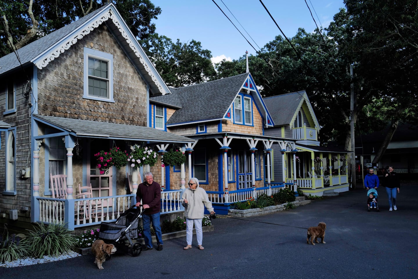 People walked their dogs through a neighborhood in Oak Bluffs in Martha’s Vineyard in 2022.