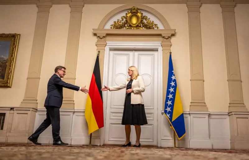 Germany's Foreign Minister Johann Wadephul (L) shakes hands with Zeljka CvijanoviC during a meeting with Bosniak, Serbian, and Croatian representatives at the start of his Western Balkans trip. The EU has offered accession prospects to the region-including Albania, Bosnia-Herzegovina, Kosovo, North Macedonia, Montenegro, and Serbia-since 2003. Michael Kappeler/dpa