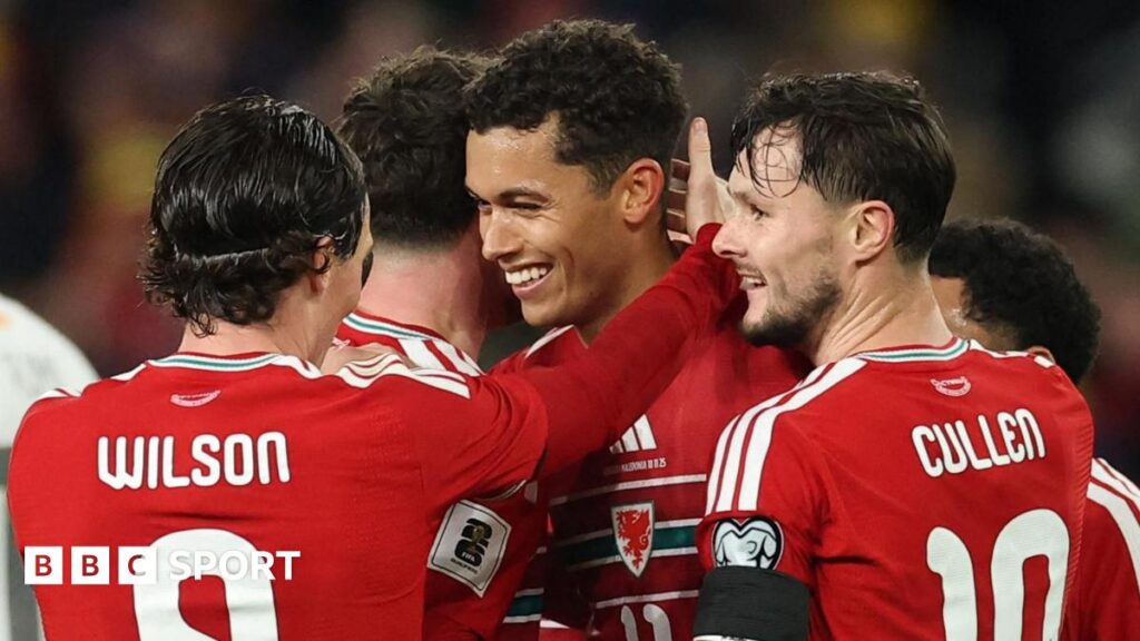 Liam Cullen (right) celebrates with Wales team-mates against North Macedonia