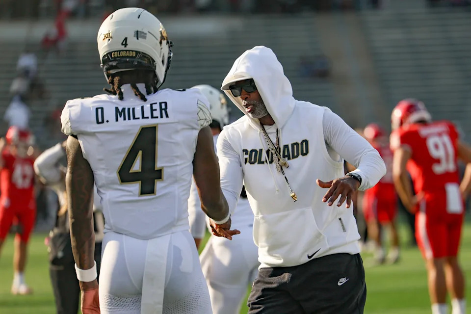 Sep 12, 2025; Houston, Texas, USA; Colorado Buffaloes head coach Deion Sanders shakes hands with wide receiver Omarion Miller (4) before the game against the Houston Cougars at TDECU Stadium. Mandatory Credit: Troy Taormina-Imagn Images