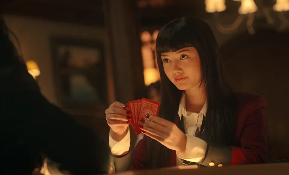 Miku Martineau as Yumeko holding cards in Bet