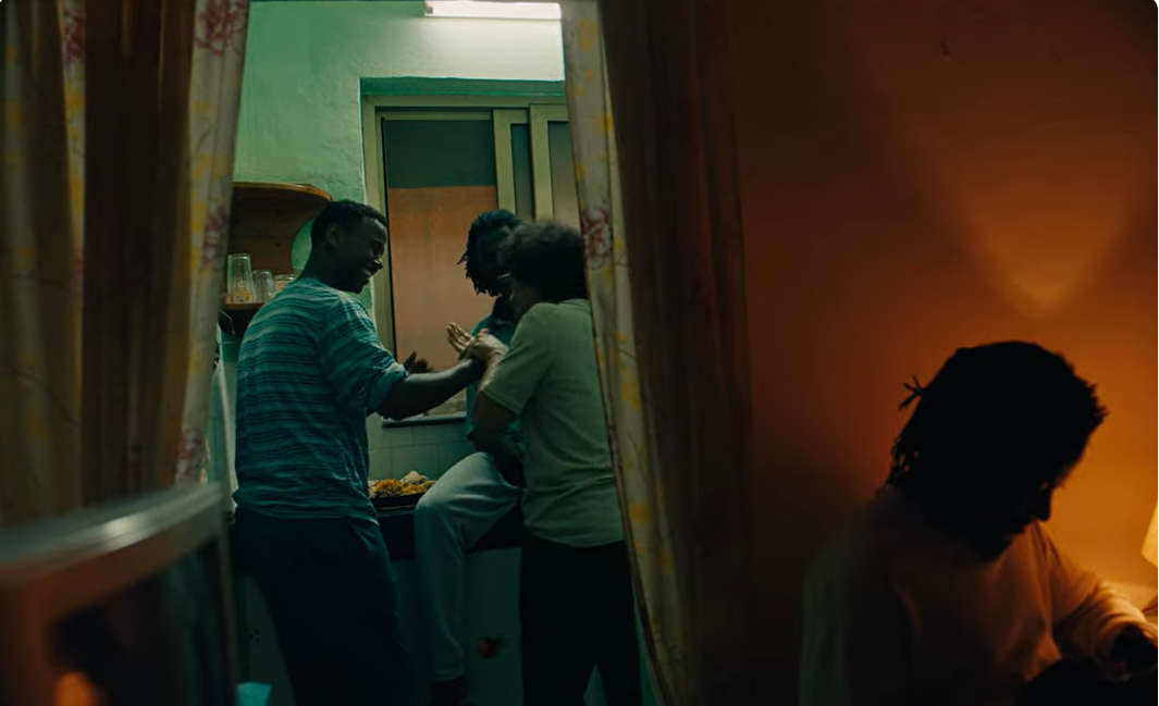 Dursa, in the stripped t-shirt, alongside the main actor and other supporting actors. Photo: Still from Youtube