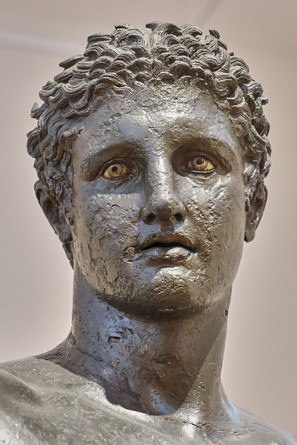 Bronze statue known as the Antikythera Youth, depicting a nude young male figure possibly representing Paris holding the apple of strife