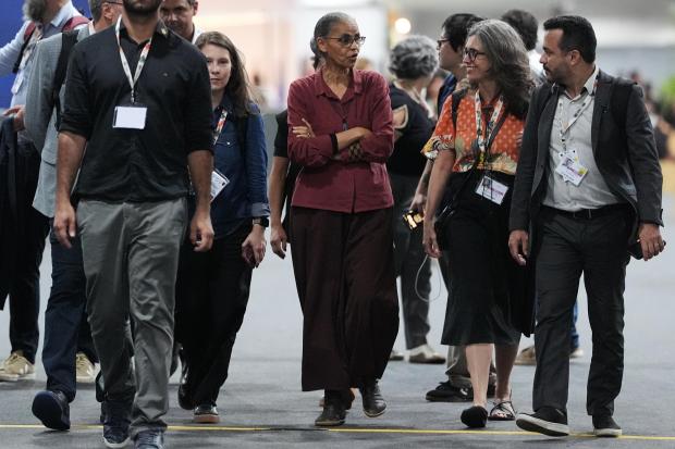 Marina Silva, Brazil environment minister, center, walks through the venue...