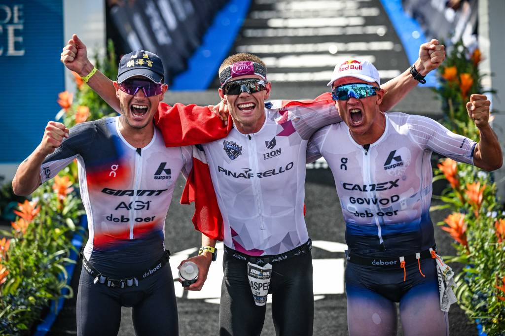 Norway's Casper Stornes (centre) celebrates Ironman worlds victory with Gustav Iden (left) and Kristian Blummenfelt. Pic credit: Ironman / Bartłomiej Zborowski / Activ’Images