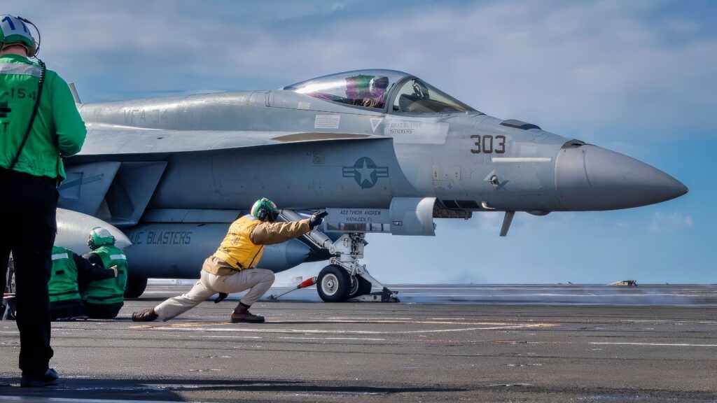 U.S. Navy Lt. Andrew Bentley signals an F/A-18E Super Hornet, assigned to the “Blue Blasters” of Strike Fighter Squadron (VFA) 34, to launch from the flight deck of the Nimitz-class aircraft carrier USS Theodore Roosevelt (CVN 71), Nov. 30, 2023. Theodore Roosevelt, the flagship of Carrier Strike Group Nine (CSG 9), is conducting integrated training exercises in the U.S. 3rd Fleet area of operations. (U.S. Navy photo by Mass Communication Specialist 3rd Class Adina Phebus)